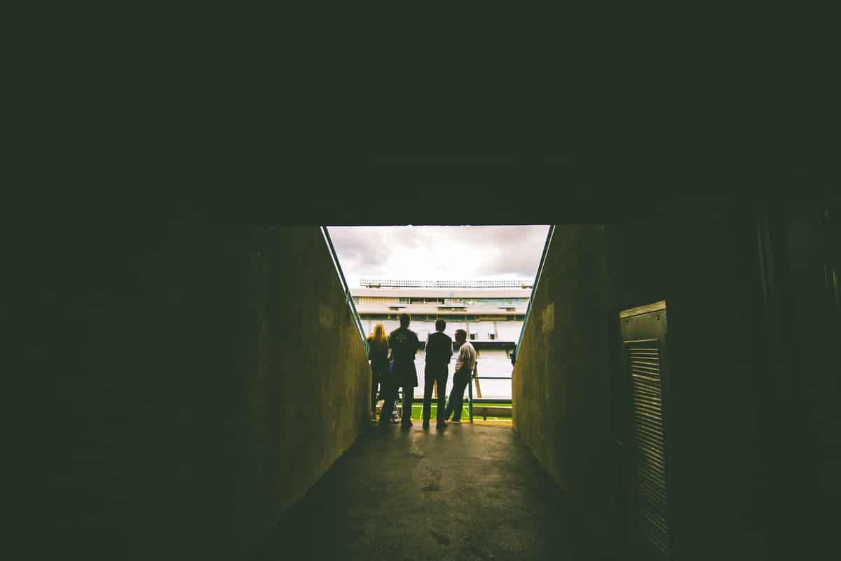 People looking at a football pitch from a stand.