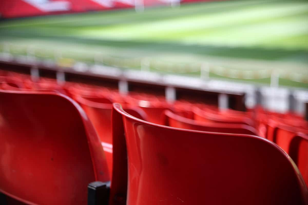 Red seats in the stands at Old Trafford football stadium.