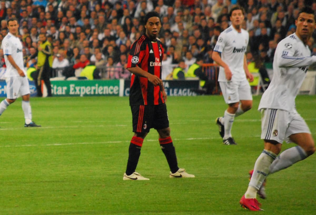 Ronaldinho and Cristiano Ronaldo playing against each other.