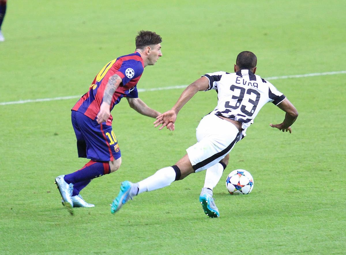 Lionel Messi taking on Patrice Evra in the 2015 Champions League final.